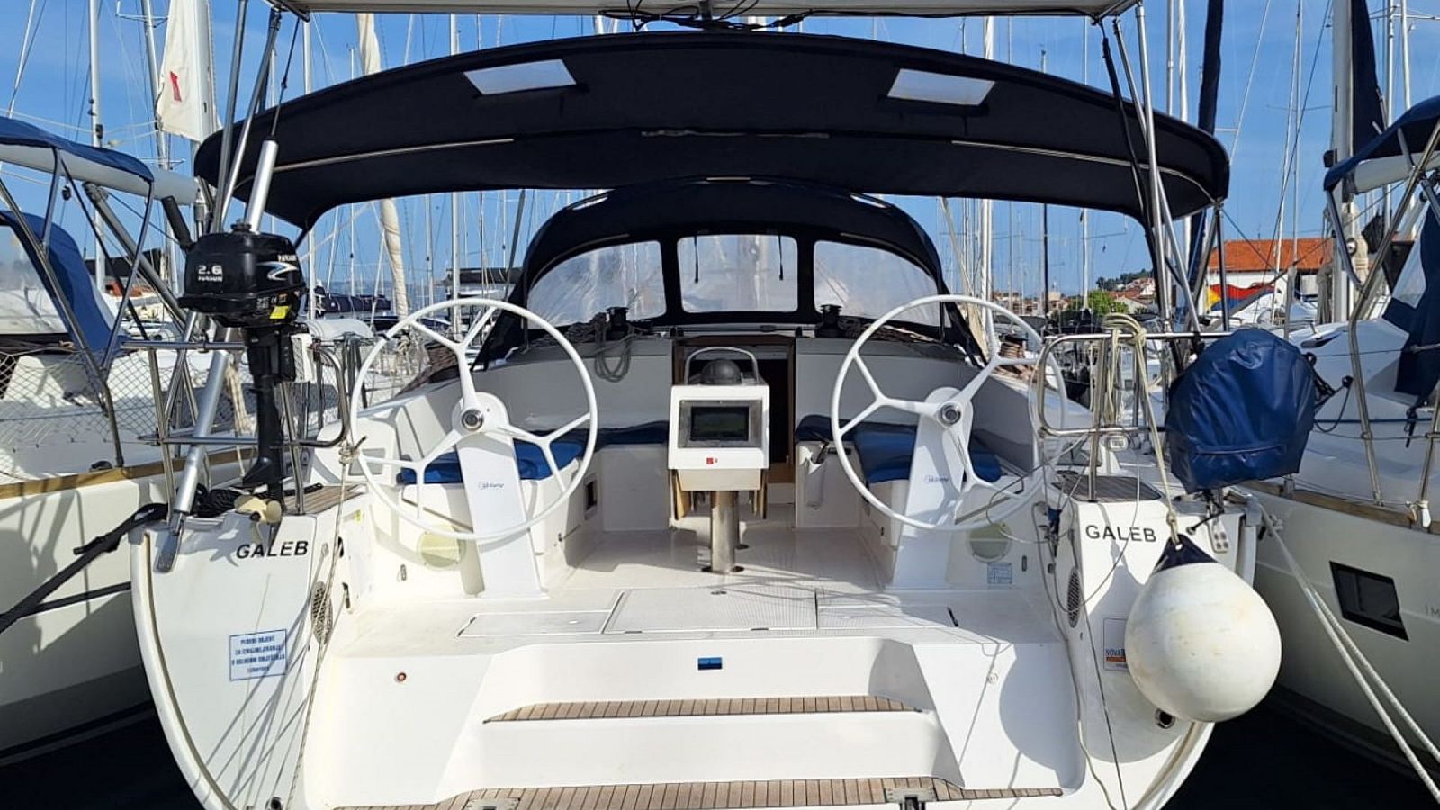 Bavaria Cruiser 46 cockpit with twin steering wheels and protective bimini