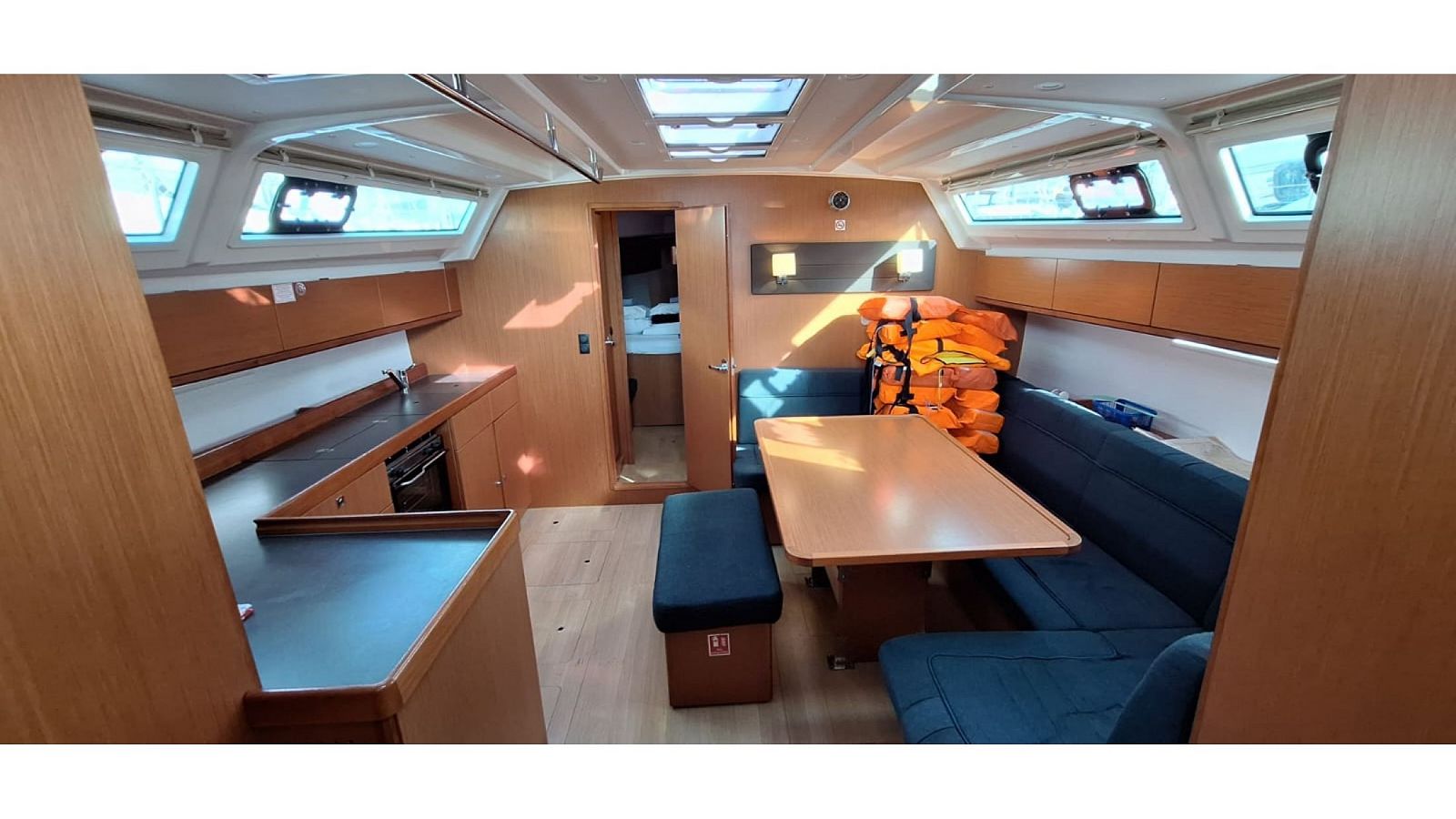 Bavaria Cruiser 46 interior saloon with U-shaped settee and galley